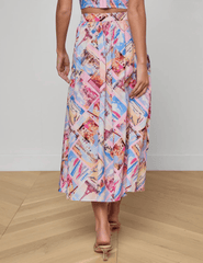 Back view of L'Agence Seina midi skirt in pink postcard print