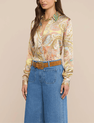 Side view of L'AGENCE Tyler Green Multi Cluster Paisley blouse styled with wide-leg jeans