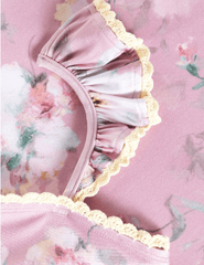 Close-up of Zimmermann Everley pink floral swimsuit with crochet trim and ruffle straps