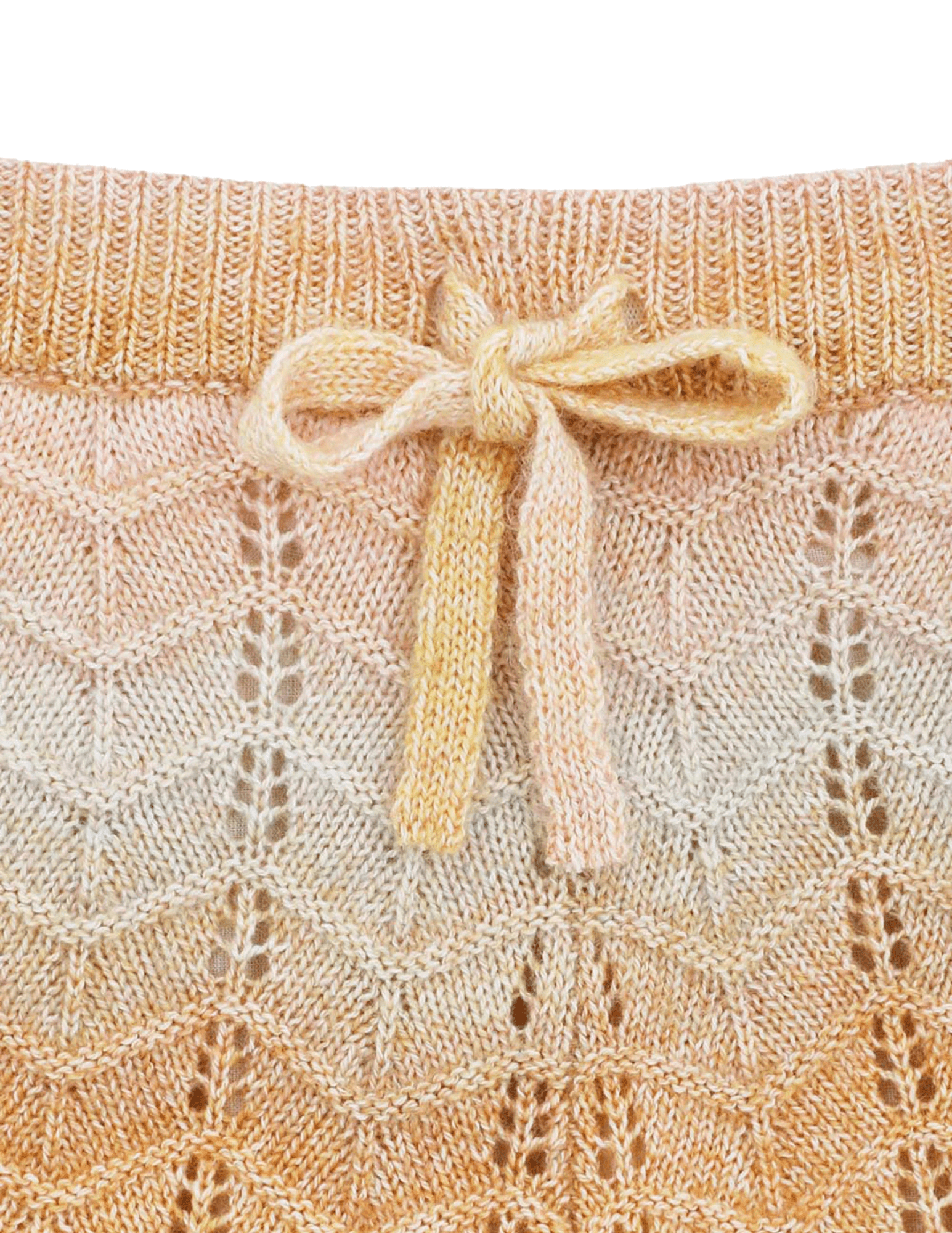 Close-up of textured chevron knit fabric and scalloped edge on Zimmermann Tallow shorts