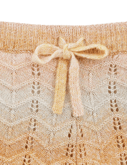 Close-up of textured chevron knit fabric and scalloped edge on Zimmermann Tallow shorts