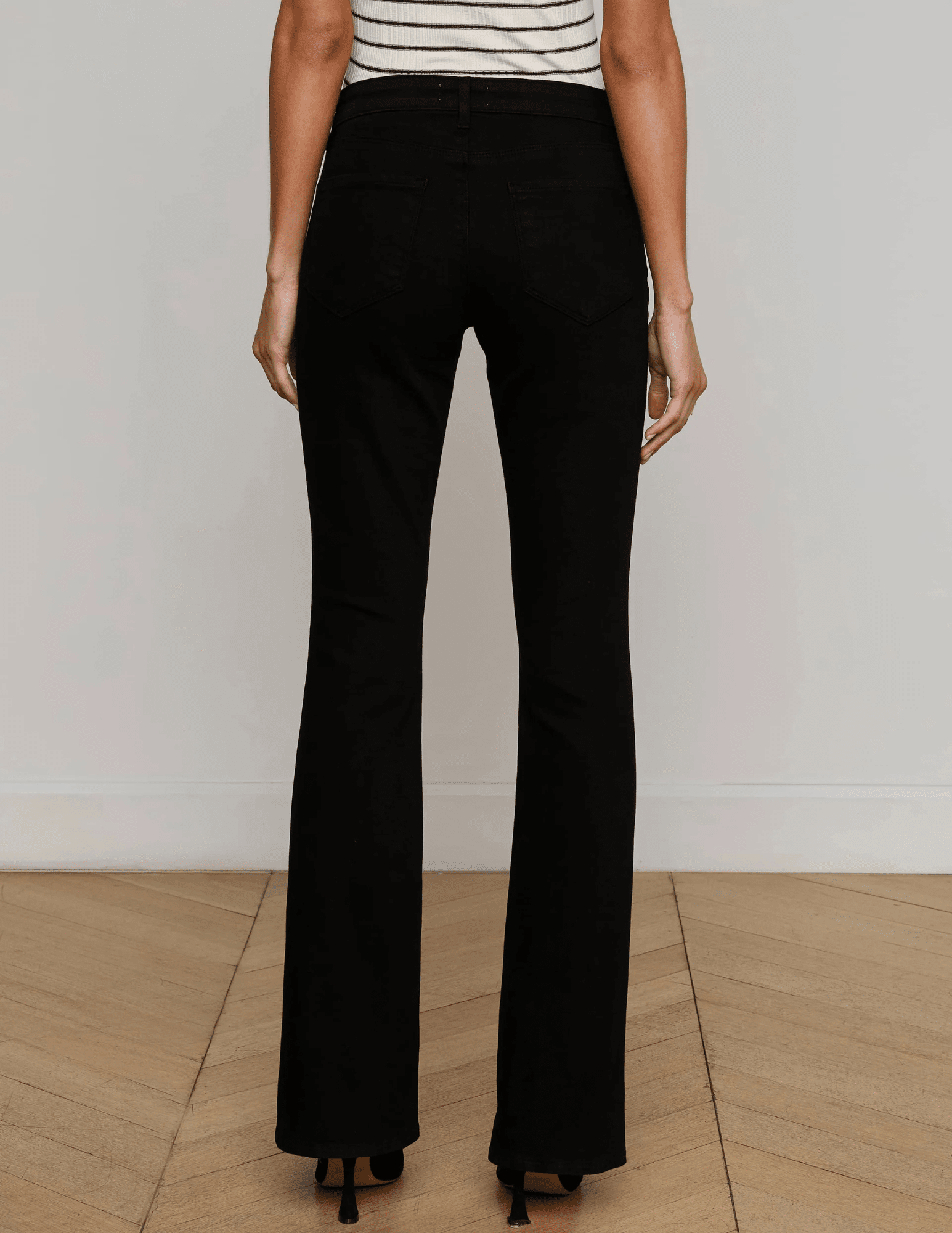 Back view of L’AGENCE Cara Low-Rise Bootcut Jeans in Noir
