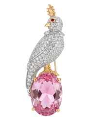 Ornate bird-shaped jewelry piece with pink gemstone  bird on a rock