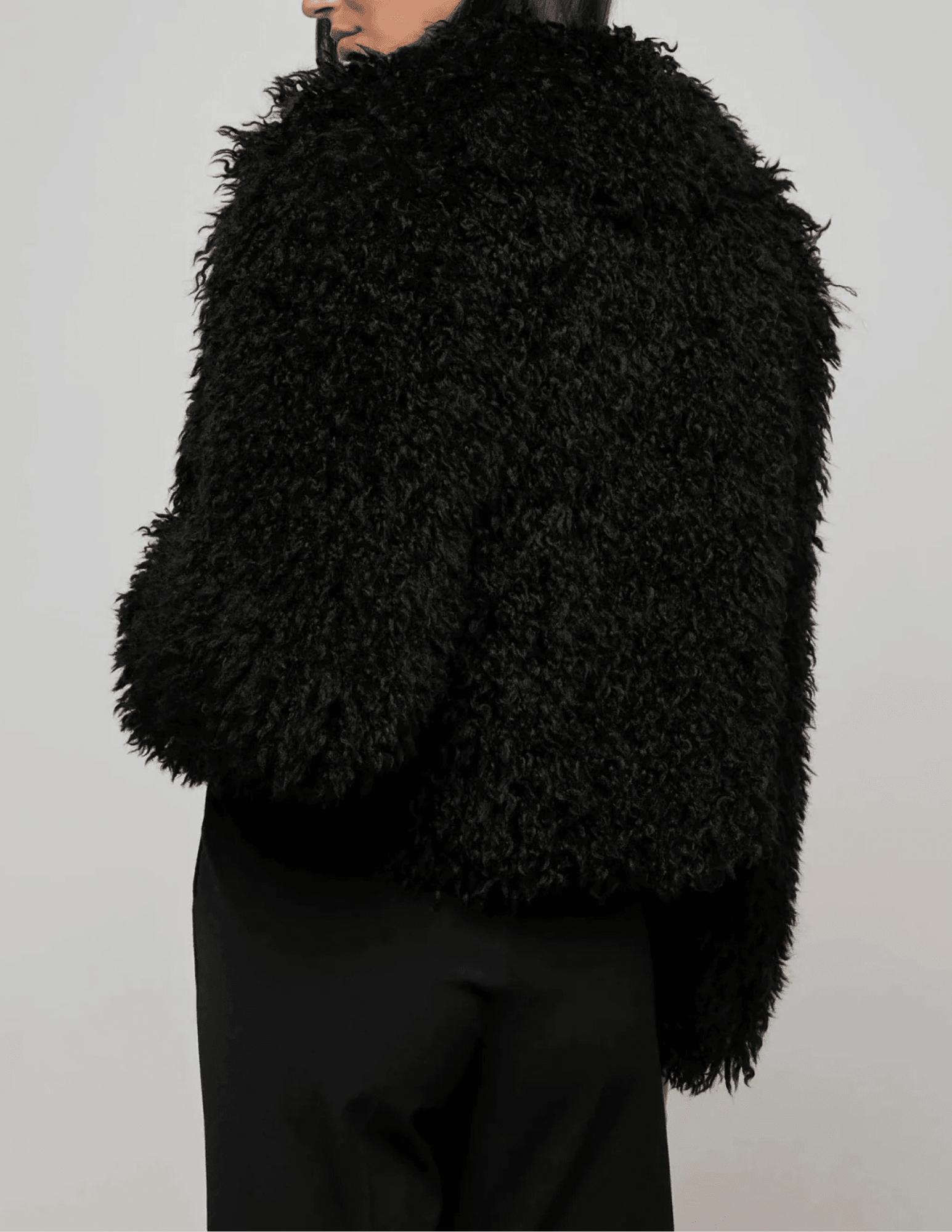 Side view of L'AGENCE Aura Crop Faux Fur Jacket in Black
