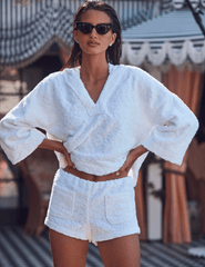 Model wearing L’AGENCE Lee Terry Cropped Hooded Poncho styled with Amiya Terry Short