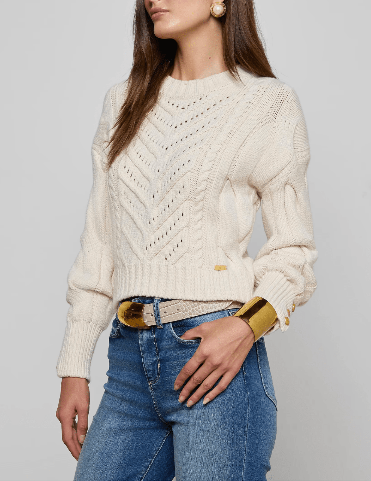 Side view of LAGENCE Storm Cable Knit Sweater in Ivory