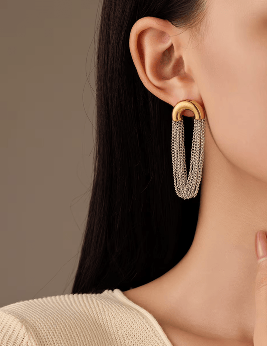 Model wearing Austin Baze Cleo Two-Tone Chain Earrings in silver and gold.