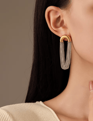 Model wearing Austin Baze Cleo Two-Tone Chain Earrings in silver and gold.