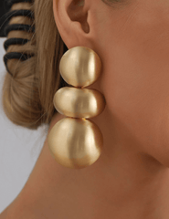 Austin Blaze Eliza statement earrings in brushed matte gold featuring a modern sculptural three-sphere drop design with standard post backing.