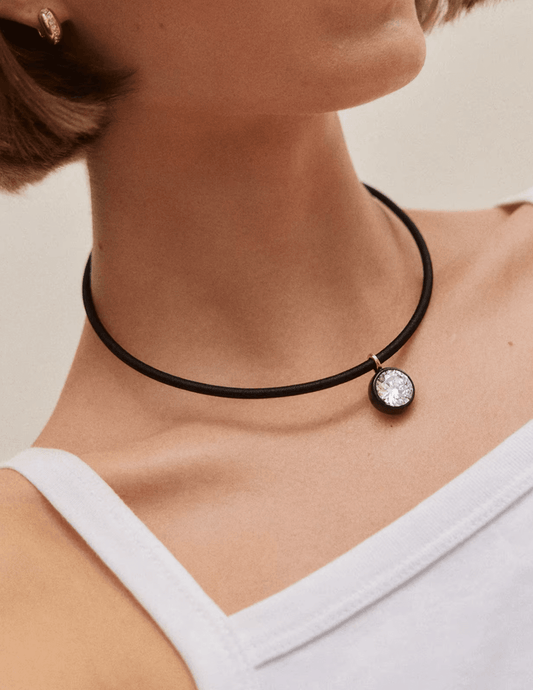 Model wearing Austin Blaze Leah Black Cord Choker Necklace with a sparkling round CZ pendant and gold-tone bezel setting.