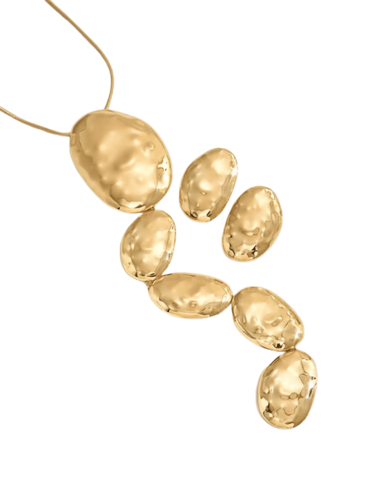 Close-up of hammered gold-tone textured oval pendants on Phoebe Necklace