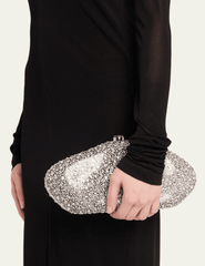 Cult Gaia crystal-inspired clutch styled with black evening outfit.