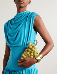 Model holding dominga Cult Gaia Grape Acrylic Clutch.
