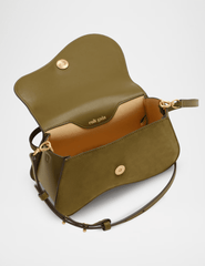 Interior view of Cult Gaia Kazia Crossbody Bag in Rosemary showing magnetic closure and lined compartment.
