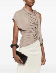 Model holding black Cult Gaia Lisse Clutch with gold hardware.