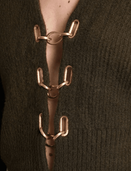 Close-up of gold chain clasp detail on Cult Gaia Mayalu Sweater