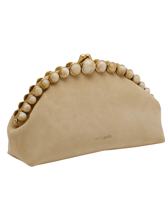 Side view of Cult Gaia Una clutch in sand suede with gold bead detail