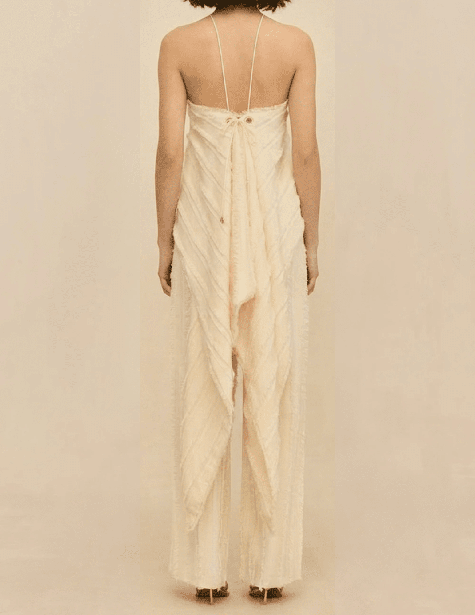 Back view of the Cult Gaia Venezia Halter Cascade Top in Off White showcasing the cascading fringe hem