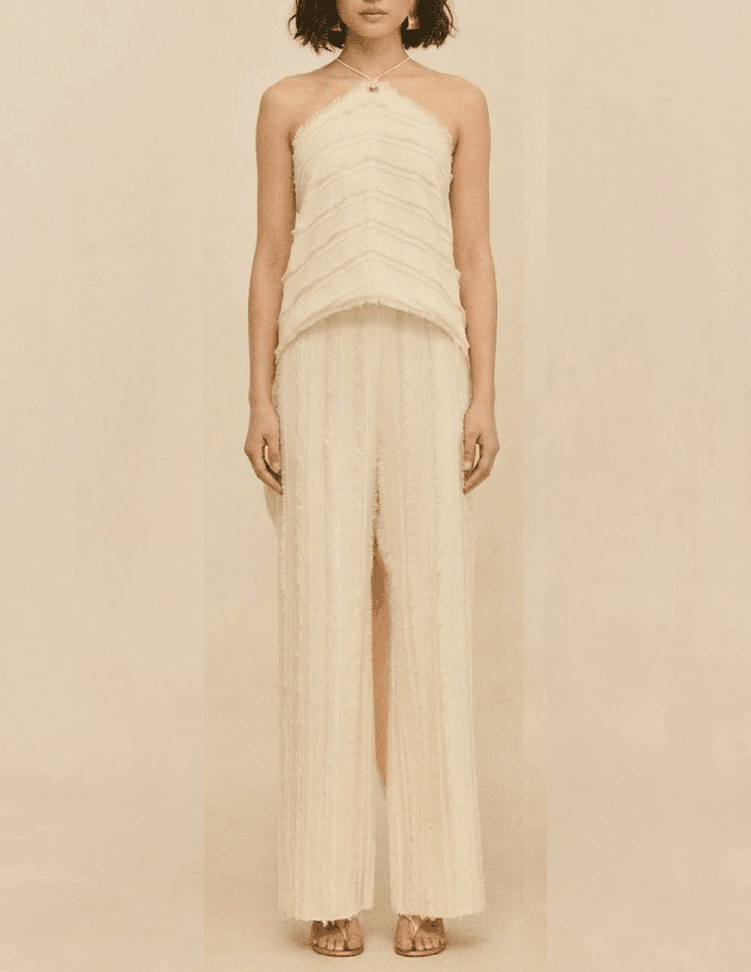 Front view of the Cult Gaia Venezia Halter Cascade Top in Off White worn on a model