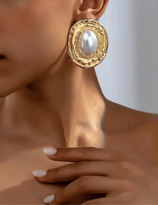 Model wearing oversized Fleur de Camélia Paris pearl and gold earrings