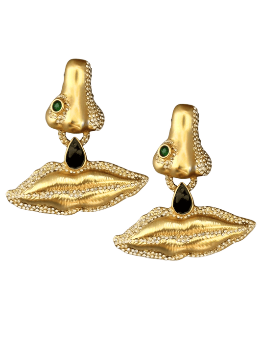 Fleur de Camélia Brielle gold abstract face motif earrings with rhinestone and green gemstone detail