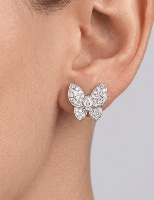 Close-up of silver pavé crystal stud earrings worn on ear