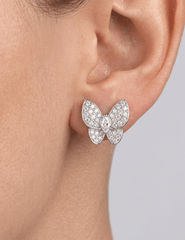 Close-up of silver pavé crystal stud earrings worn on ear