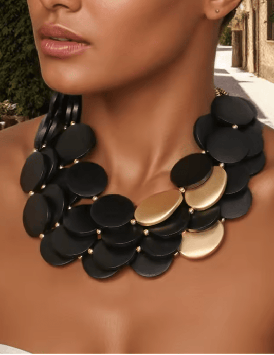 Model wearing the Maxie Wooden Necklace in black and gold statement design