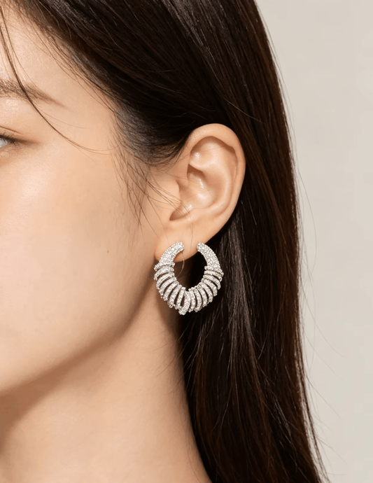 Model wearing Fleur de Camélia Parker CZ Silver Earrings showcasing the sparkling open-circle silhouette and statement design.