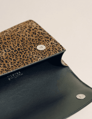 Interior of Hunting Season leopard print suede clutch with leather lining and magnetic fastening