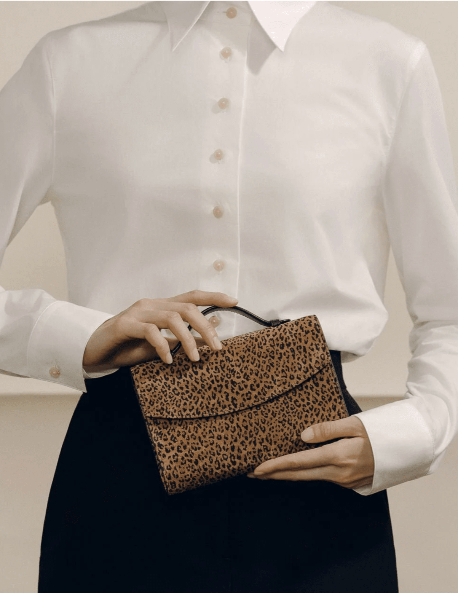 Hunting Season leopard suede top handle clutch styled with white blouse and black trousers