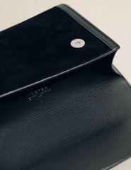 Interior of Hunting Season black suede clutch with leather lining and magnetic fastening