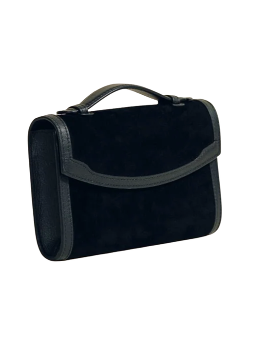 Angled view of Hunting Season black suede clutch with sculpted leather trim