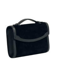 Angled view of Hunting Season black suede clutch with sculpted leather trim