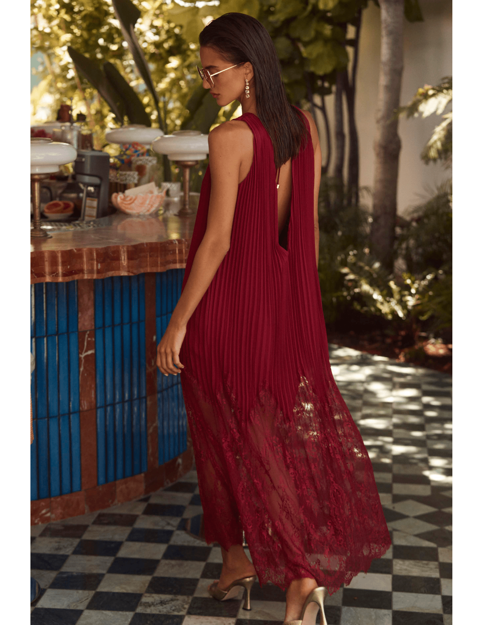 Back lifestyle view of L’AGENCE Adalynn Combination Pleated Maxi Dress in Black Cherry