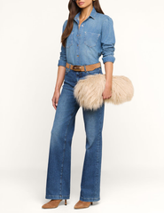 Model carrying L'AGENCE Adelina Faux Fur Clutch in Biscuit.