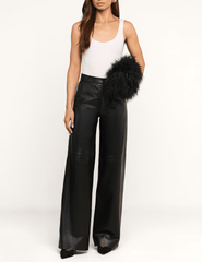 Model carrying the L'AGENCE Adelina Faux Fur Clutch in Black.