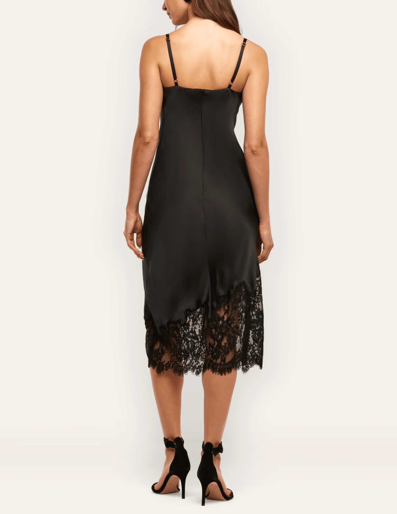 Back view of L'AGENCE Adrienne black silk midi dress with spaghetti straps and floral lace hem