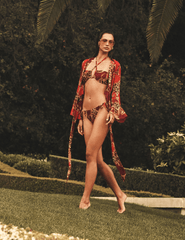Model wearing L'AGENCE Ambala baroque leopard cover-up top styled with coordinating luxury resort wear.