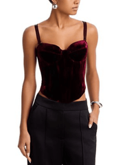 Model wearing L'AGENCE Ariana Deep Port Velvet Corset with black tailored trousers.