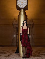 Model wearing L’AGENCE Aya Tweed Midi Dress in bold red and black houndstooth pattern.”