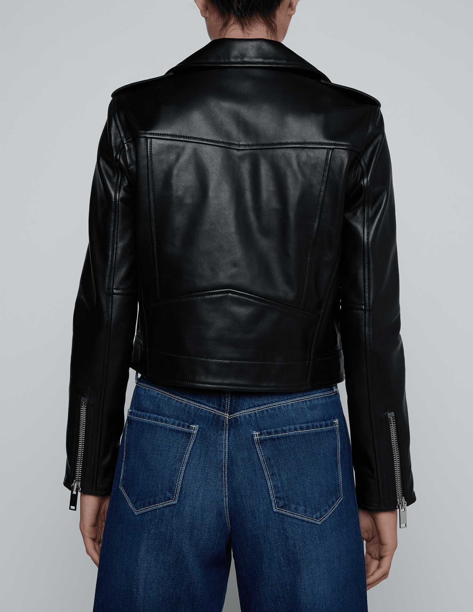 Back view of cropped L’AGENCE Blakely Biker Jacket in black lambskin leather.