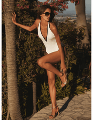 Editorial image of LAGENCE Breana white one piece swimsuit with black trim