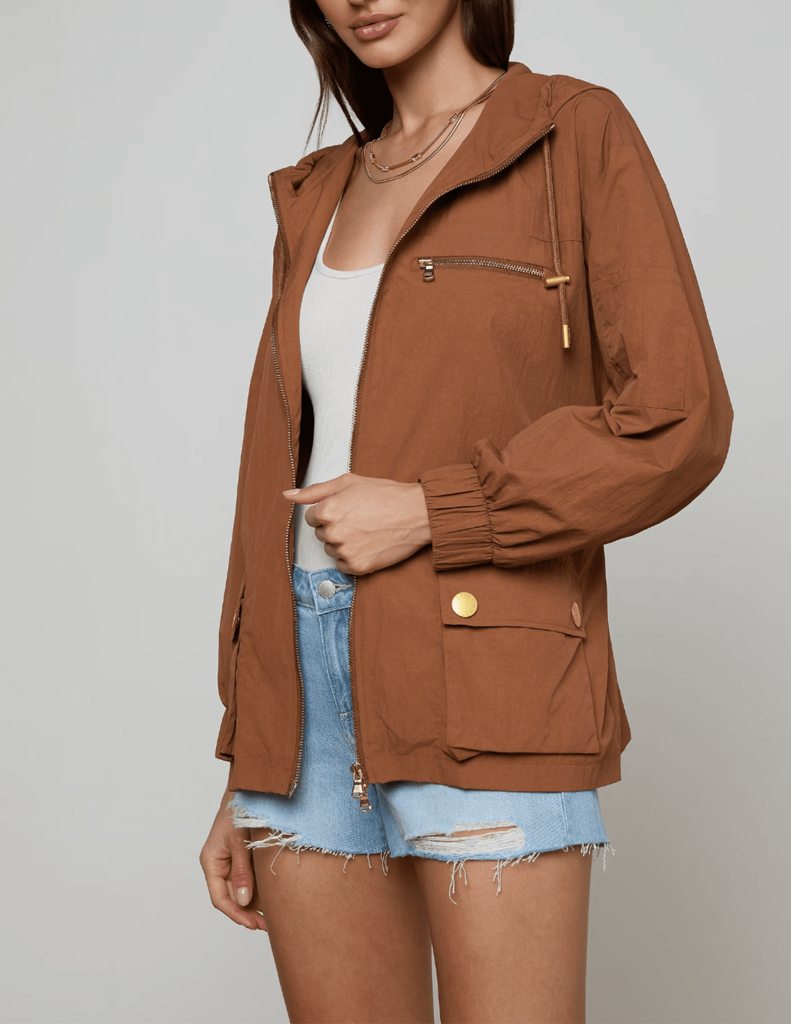 Side view of L’AGENCE Calina windbreaker jacket in fawn with gold hardware