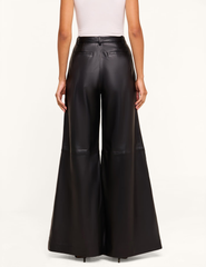 Back view of L'AGENCE Chelsy Black Leather Wide Leg Pants featuring a flowing wide-leg fit.