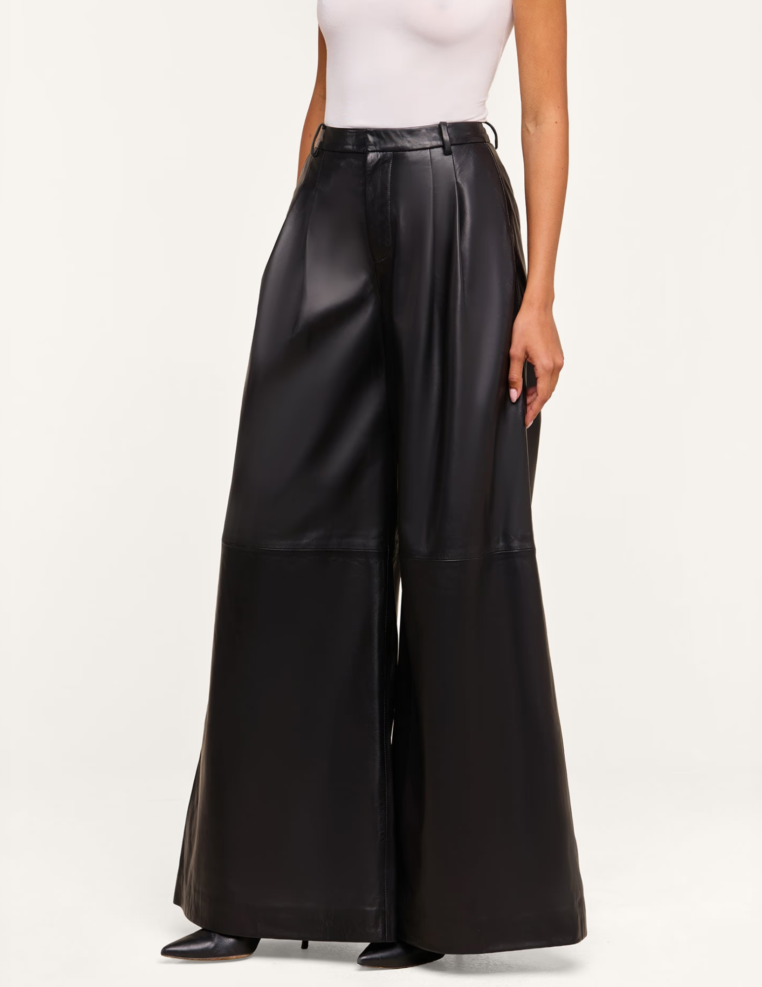 Side view of L'AGENCE Chelsy Black Leather Wide Leg Pants featuring a flowing wide-leg fit.