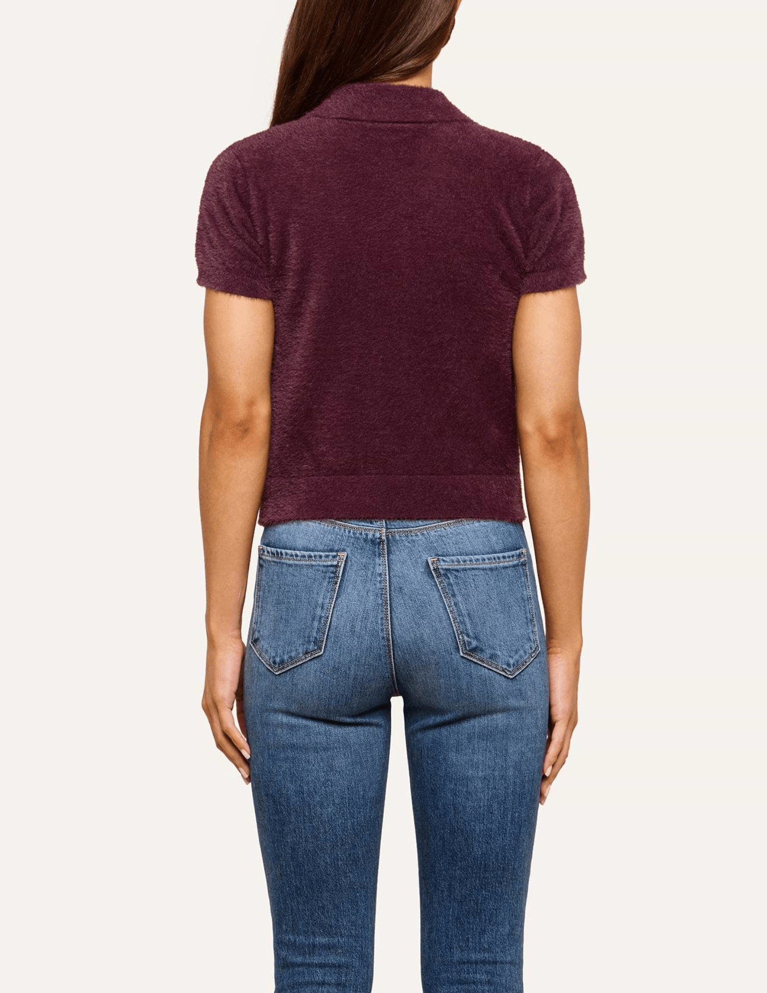 Back view of L'AGENCE Cirrus Short Sleeve Cropped Polo in Dark Plum showing the plush knit texture and cropped hem.