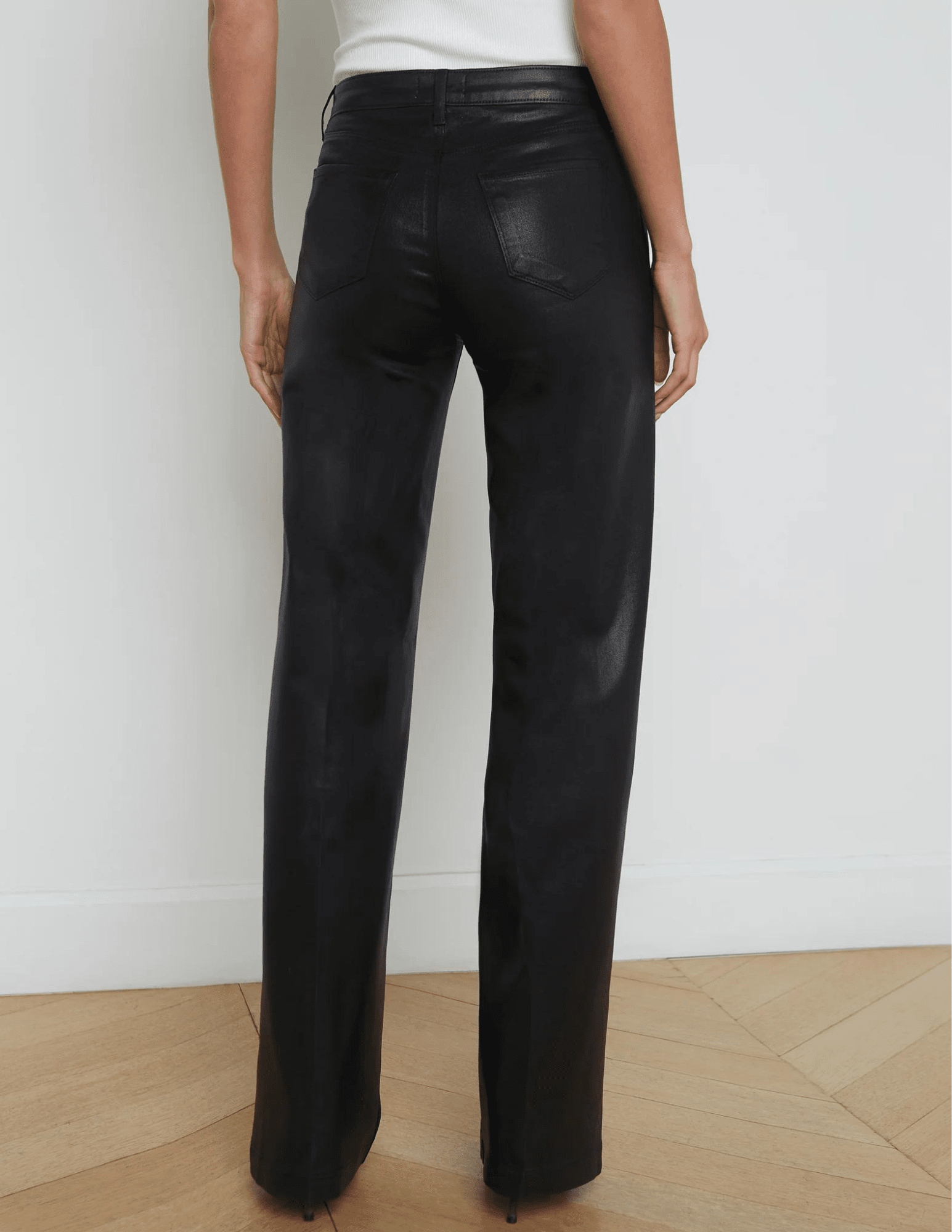 L'AGENCE Clayton high rise wide leg coated jeans in Black Coated, sleek women’s denim with a glossy finish and relaxed wide leg silhouette back model view
