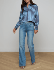 Model wearing L’AGENCE Cosette satin cropped blouse in blue multi stripe