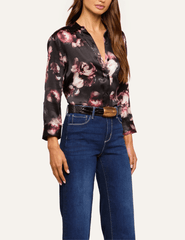 Side view of L'AGENCE Dani floral silk blouse showcasing its high-low shirttail hem and romantic distressed rose pattern.